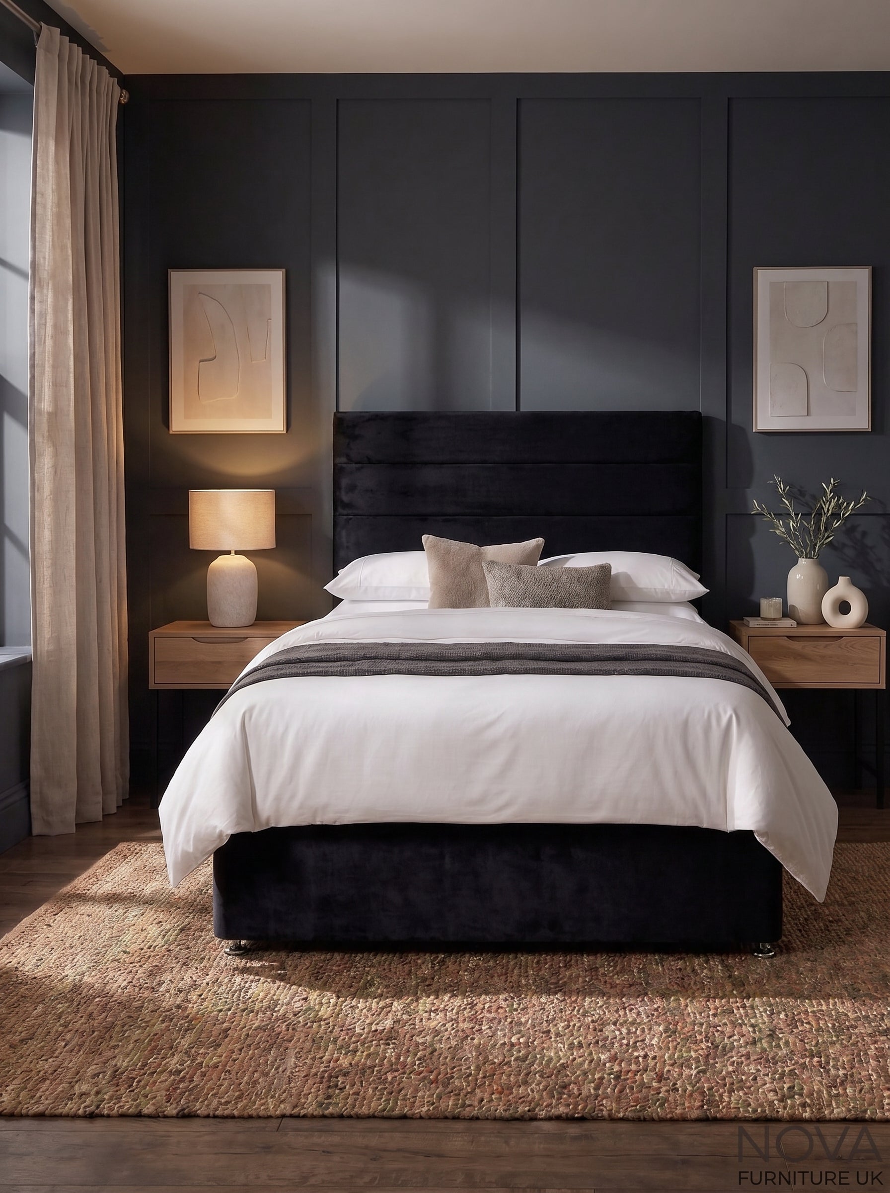 A modern bedroom featuring a black upholstered bed frame with white bedding, set against a dark paneled wall with matching bedside tables, lamps, and artwork.